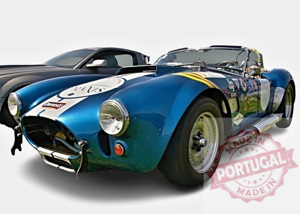 Ac cobra 427 parked next to a ford mustang, showing racing stickers | Ac cobra 427 with racing stickers parked next to a more modern Ford Mustang, both on a white background - Realized with Pictrs.com