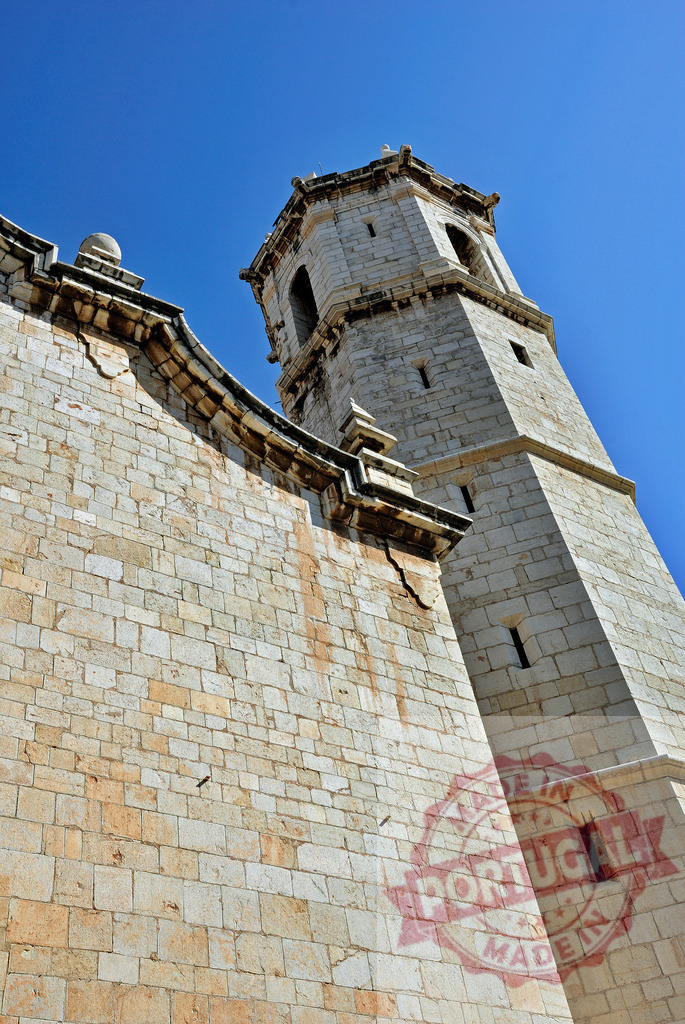 Peñíscola castle bell tower under blue sky | Stone bell tower and fortress walls reaching towards a clear blue sky in Peñíscola, Spain - Realized with Pictrs.com
