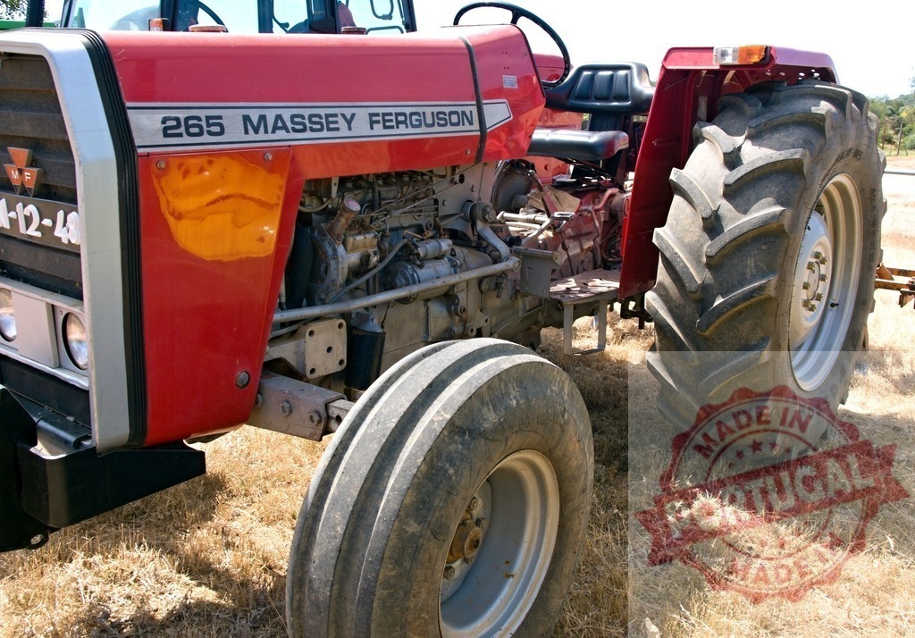 Massey Ferguson 265 tractor standing in dry field | Red Massey Ferguson tractor parked outdoors, ready for farming work - Realized with Pictrs.com