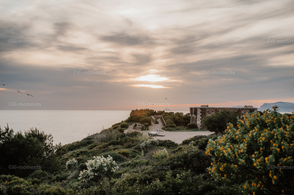Abendstimmung an der Côte d’Azur | Mediterrane Pflanzen, eine Landzunge mit historischem Wach- und Aussichtspunkt und ein Sonnenuntergang über dem Meer – dieses stimmungsvolle Foto fängt die magische Abendstimmung an der Côte d’Azur perfekt ein. - Realisiert mit Pictrs.com