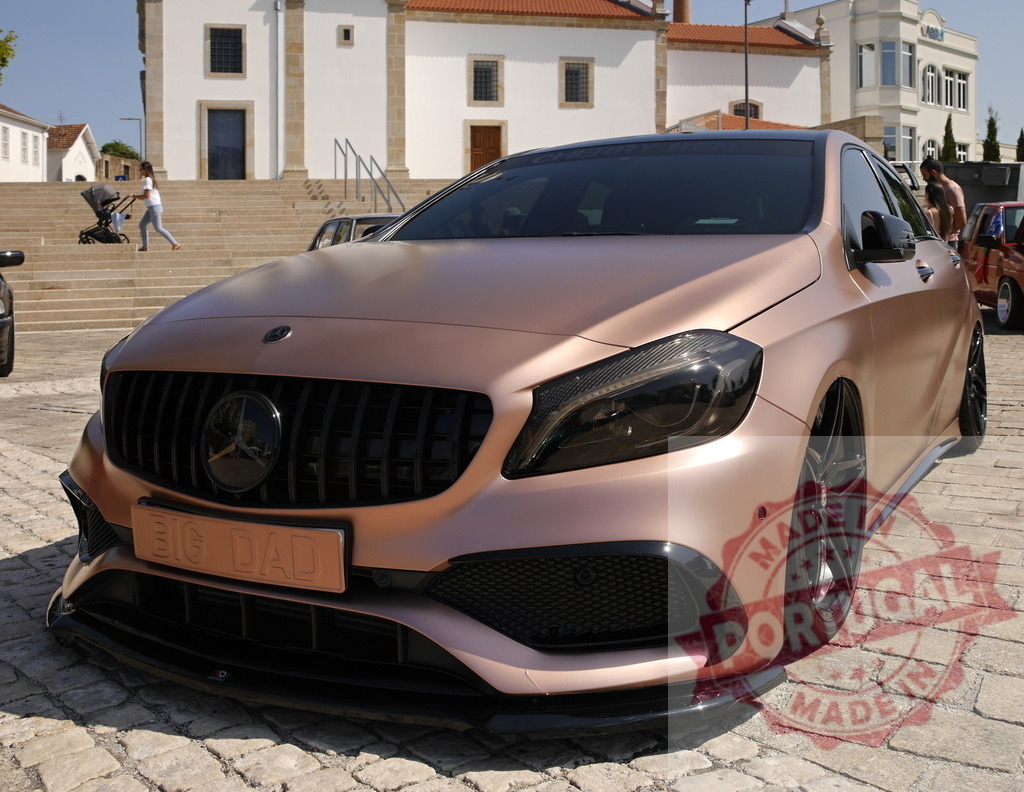 Mercedes-Benz A-Class custom car displaying rose gold matte wrap | Custom built Mercedes-Benz A-Class car parked on cobblestone in a European town square - Realized with Pictrs.com