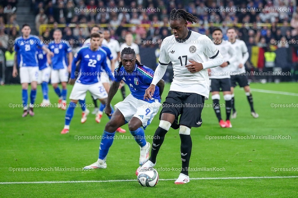 DFB23032501094 | 23.03.2025, Fußball, Viertelfinale UEFA Nations League, Deutschland - Italien, Signal Iduna Park, Saison 2024 2025: Moise Kean (ITA #09) im Zweikampf gegen Yann Aurel Bisseck (GER #17) DFB regulations prohibit any use of photographs as image sequences and or quasi-video.