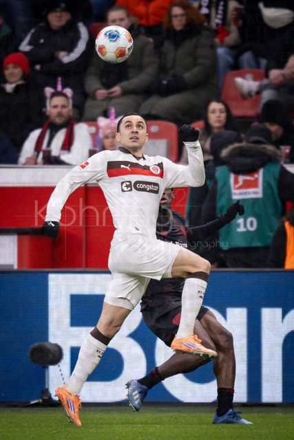 Bayer 04 Leverkusen vs. FC St. Pauli, 14.02.2026 | LEVERKUSEN, GERMANY - FEBRUARY 14:  Manolis Saliakas (FC St. Pauli, 2), Ernest Poku (Bayer 04 Leverkusen, 19) during the Bundesliga match (gameday 22)  between Bayer 04 Leverkusen vs. FC St. Pauli at BayArena on February 14, 2026 in Leverkusen, Germany. (Photo by Axel Kohring/Beautiful Sports Int.)DFL REGULATIONS PROHIBIT ANY USE OF PHOTOGRAPHS AS IMAGE SEQUENCES AND/OR QUASI-VIDEO.