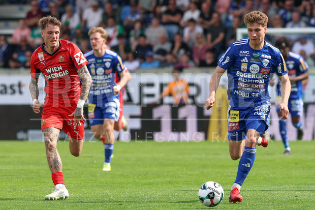 TSV Egger Glas Hartberg vs SK Rapid Wien – Championship Group    | Hartberg, Austria, 19.Apr.26 - SOCCER - ADMIRAL Bundesliga, TSV Egger Glas Hartberg vs SK Rapid Wien. The image shows Bendeguz Bolla (SK Rapid Wien) and Marco Hoffmann (Hartberg). 