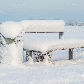 Verschneite Bank in winterlicher Stille