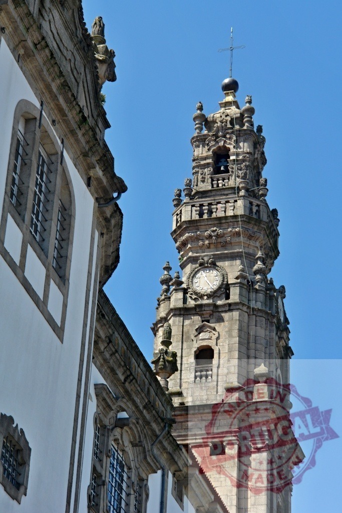 Historic church clock tower against blue sky | Ornate baroque church bell tower with a clock detail on a clear day - Realized with Pictrs.com