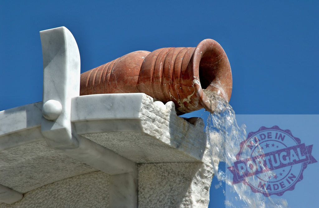 Amfora fountain pouring water against clear blue sky | Amfora fountain sculpted from marble and terra cotta pouring refreshing water under a clear blue sky - Realized with Pictrs.com