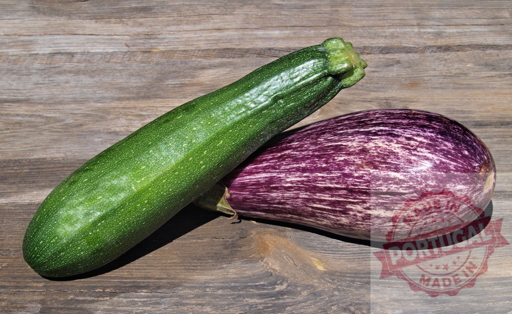 Green zucchini and striped eggplant on wooden background | Zucchini and eggplant resting on rustic wood, representing organic vegetables and healthy eating - Realized with Pictrs.com