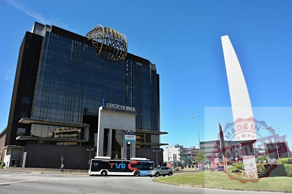 Braga railway station building with modern architecture and bus. Norte - Portugal | Modern architecture of Braga railway station under a clear blue sky, with a bus passing by - Realized with Pictrs.com