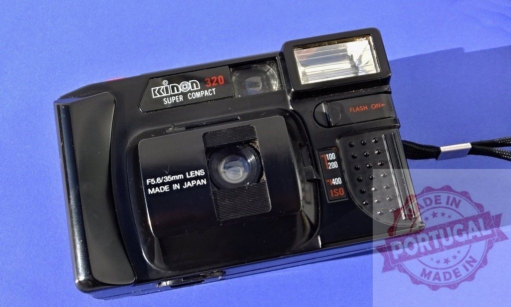Kinon 320 Super Compact 35mm film camera vintage photography | Kinon 320 Super Compact 35mm film camera for analog photography on blue background - Realized with Pictrs.com