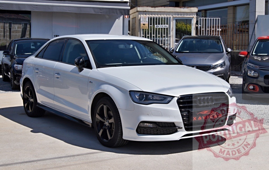 White Audi A3 sedan parked at XAVICAR dealership | White Audi A3 sedan parked outdoors at a car dealership on a sunny day - Realized with Pictrs.com