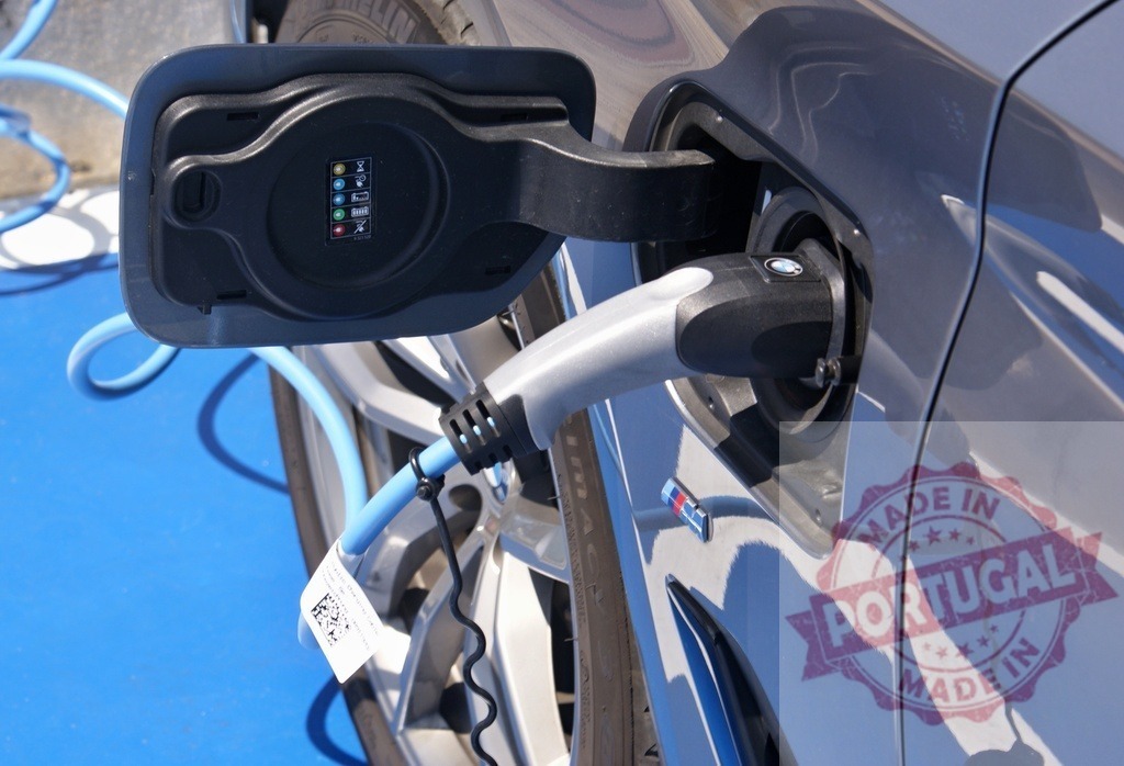 BMW electric vehicle charging at public station | Electric car charging with public charger, promoting sustainable transport - Realisiert mit Pictrs.com