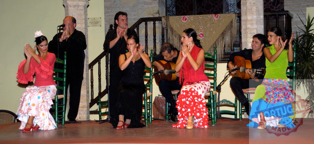 Flamenco artists performing traditional Spanish dance and music | Flamenco dancers and musicians performing on stage portraying Spanish culture - Realized with Pictrs.com