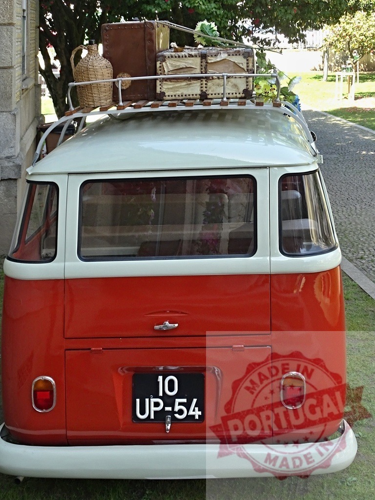 Volkswagen Kombi van with luggage on roof | Classic Volkswagen T1 van parked with vintage luggage on its roof rack, representing freedom and travel - Realized with Pictrs.com