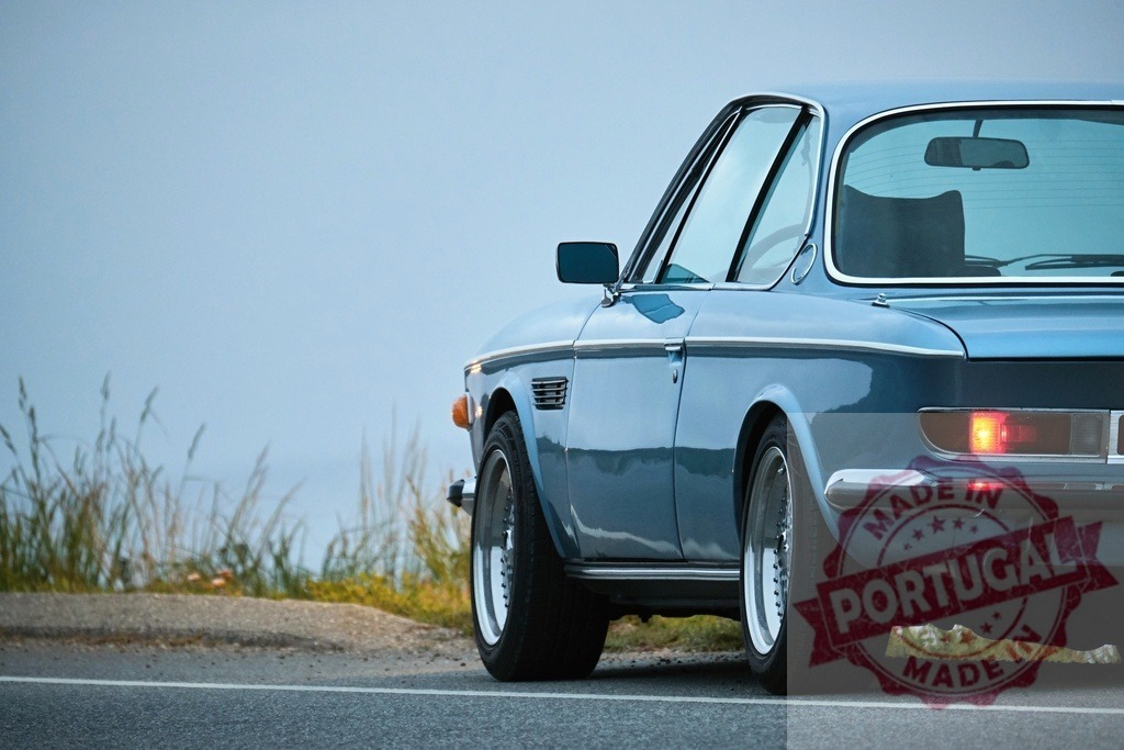 Classic BMW E9 Coupe parked on the side of a coastal road | Vintage BMW E9 Coupe parked on the side of a scenic coastal road, evoking a sense of timeless style and automotive history - Realisiert mit Pictrs.com