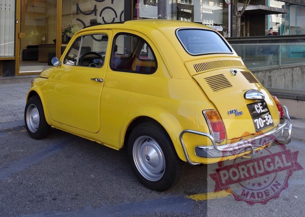 Classic yellow Fiat 500 parked on a city street | Small vintage yellow Fiat 500 parked on a city side street, showing its classic design - Realized with Pictrs.com
