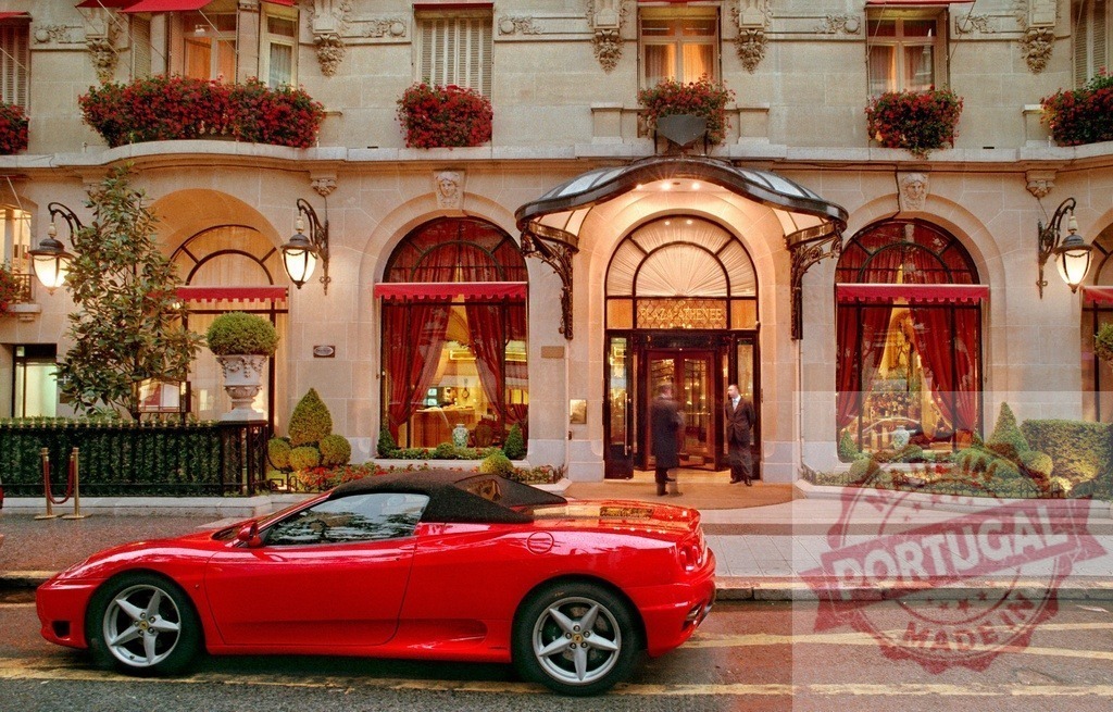 Red Ferrari parked outside Hotel Plaza Athénée Paris | Red sports car parked on a street outside a luxury Paris hotel - Realized with Pictrs.com