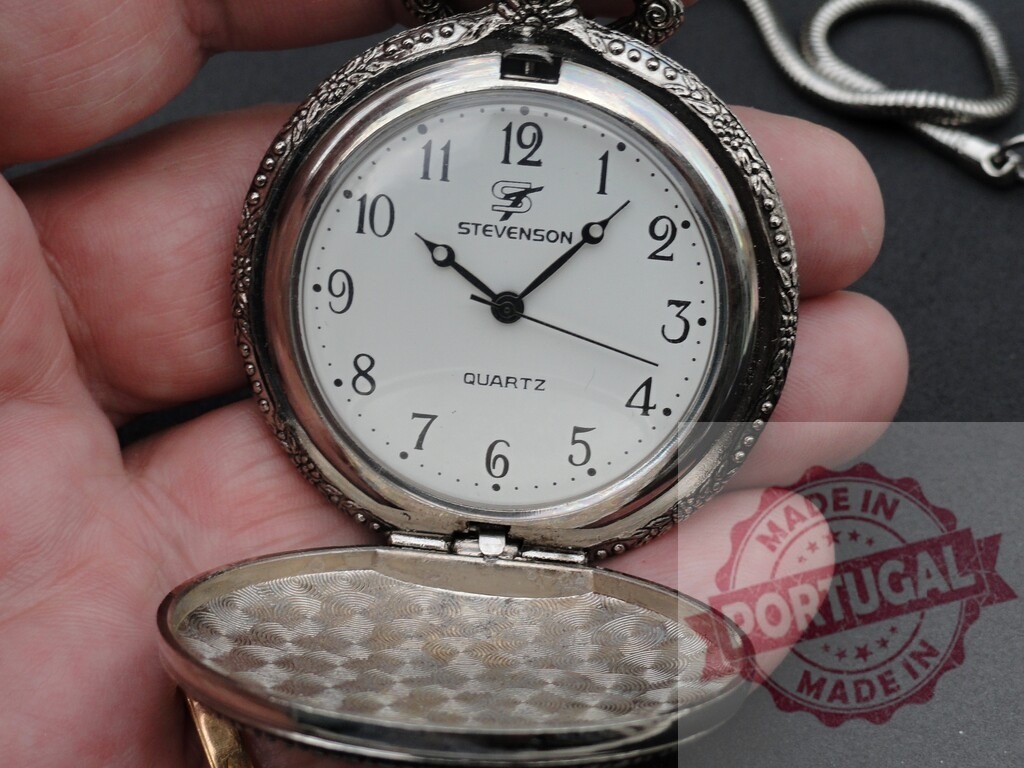 Hand holding open silver pocket watch showing time | Hand holding an open silver Stevenson quartz pocket watch displaying time against a dark background - Realized with Pictrs.com