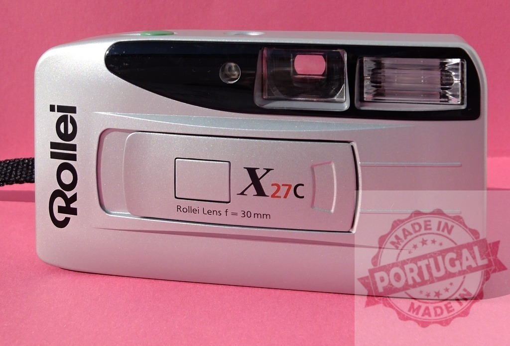Rollei X27C compact 35mm film camera on pink background | Rollei X27C vintage point and shoot camera depicting retro photography equipment - Realized with Pictrs.com