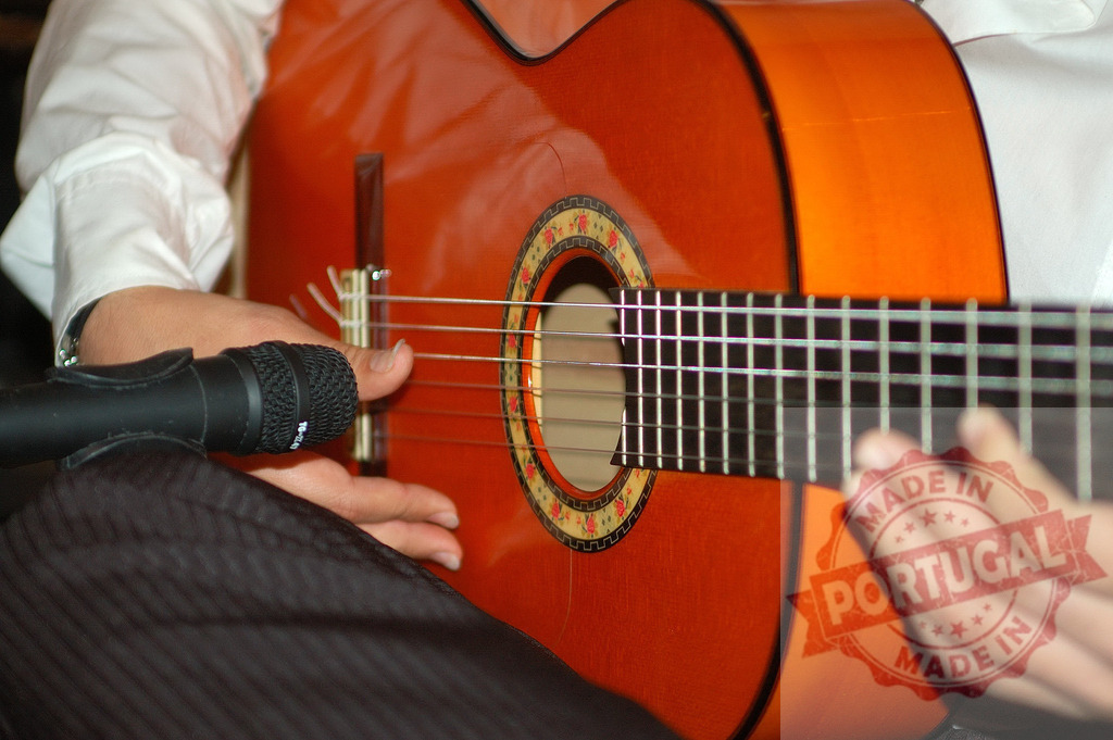 Musician playing acoustic guitar using live microphone | Musician's hands playing classical acoustic guitar with a dynamic microphone capturing sound - Realized with Pictrs.com