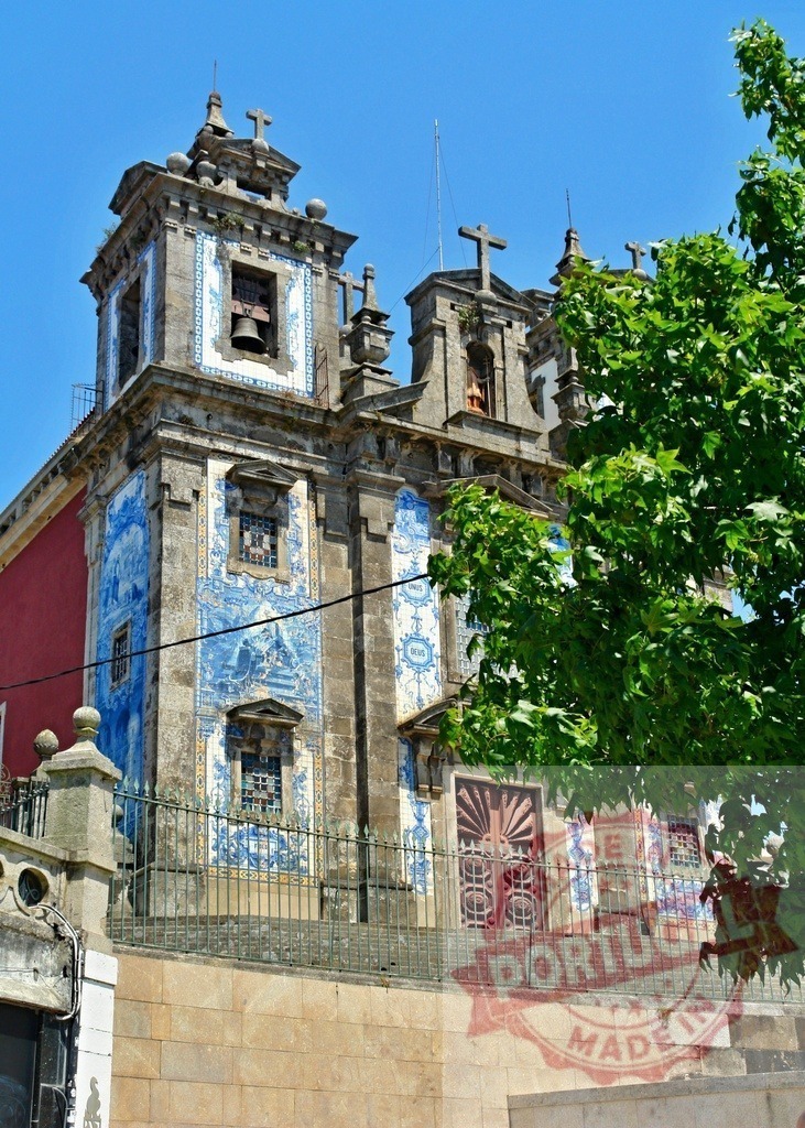 Igreja de Santo Ildefonso church facade in Porto, Portugal. Porto - Portugal | Igreja de Santo Ildefonso, a Baroque church, features blue azulejo tiles under a clear sky - Realized with Pictrs.com