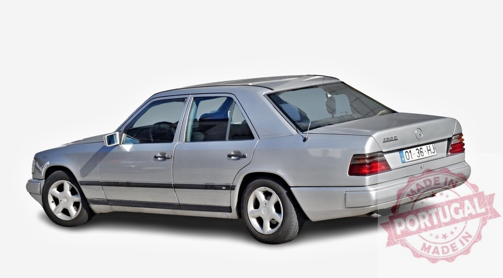 Silver Mercedes-Benz 230E parked on white background | Classic Mercedes-Benz 230E sedan parked on a white background, showcasing its elegant design - Realized with Pictrs.com