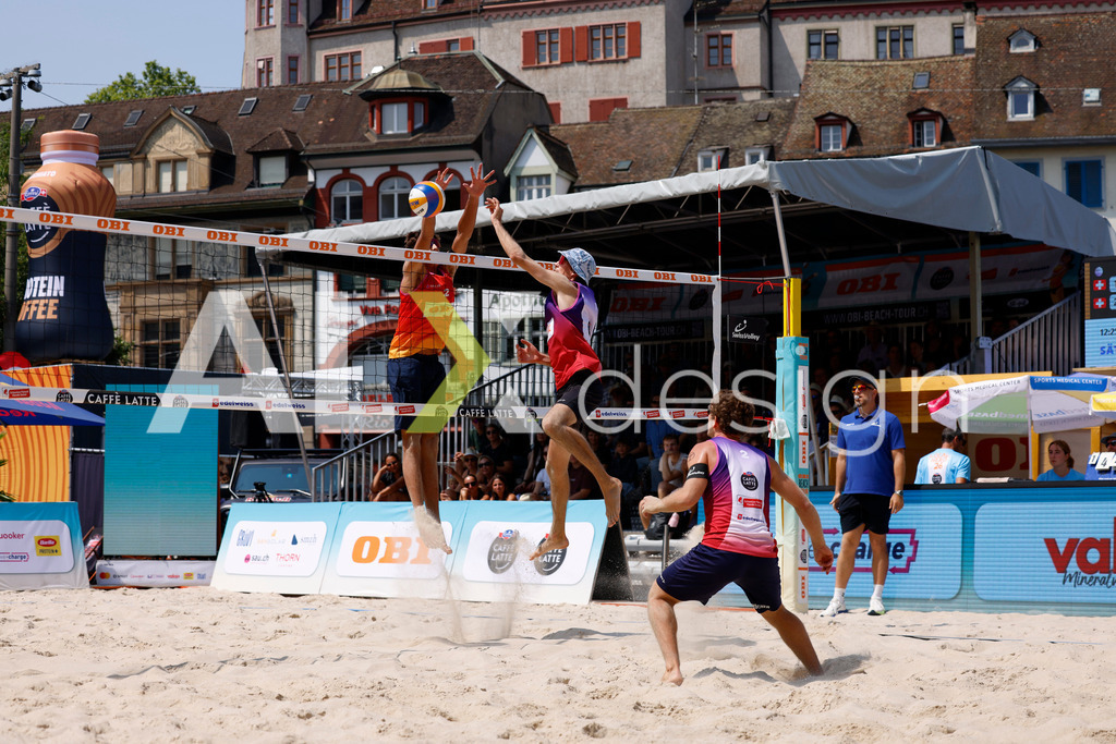 Obi BeachTour 2026 - Basel | BASEL, SWITZERLAND - JULY 19: SIMON HAGENBUCH (SUI) attack / spike against LUC EMANUEL FLÜCKIGER (SUI) block during the Obi BeachTour 2026 match between DILLIER / FLÜCKIGER (SUI) and HAGENBUCH / HAUSSENER (SUI) at Barfüsserplatz on July 19, 2026 in Basel, Switzerland. - Realisiert mit Pictrs.com