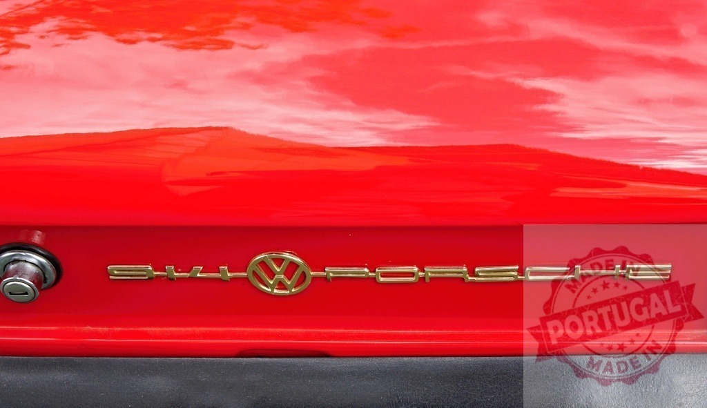 Volkswagen-Porsche 914 gold emblem on a red classic car | Red Volkswagen-Porsche 914 vintage car showing its gold branding - Realized with Pictrs.com