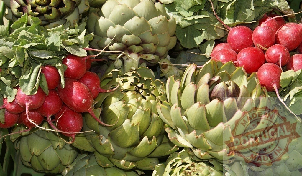Fresh artichokes and radishes at a farmers market | Fresh artichokes and red radishes with green leaves displayed for sale - Realized with Pictrs.com