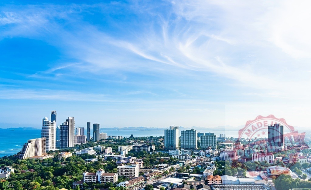 Pattaya city skyline with ocean and blue sky | Pattaya cityscape showing buildings along coastline with beautiful sky - Realized with Pictrs.com