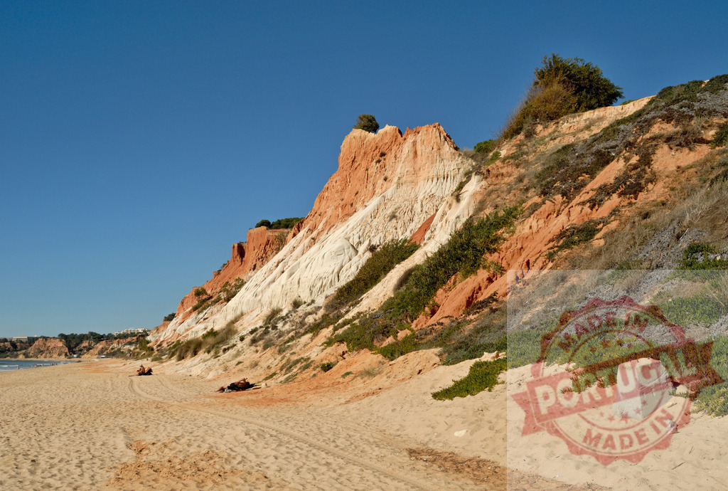 Algarve coast erosion forming colorful cliffs and sandy beach | Sandstone cliffs showing natural erosion and stratification along a beautiful Portuguese beach - Realized with Pictrs.com