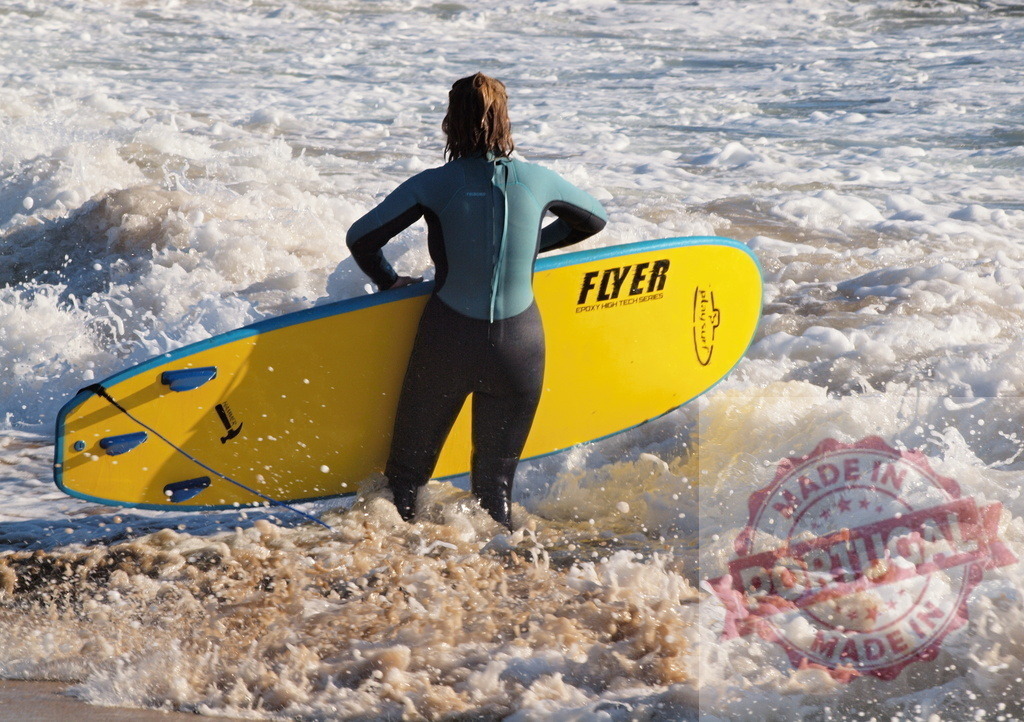 Surfer girl entering the ocean with yellow surfboard | Surfer girl walking into the ocean with her yellow surfboard, getting ready to surf the waves - Realized with Pictrs.com