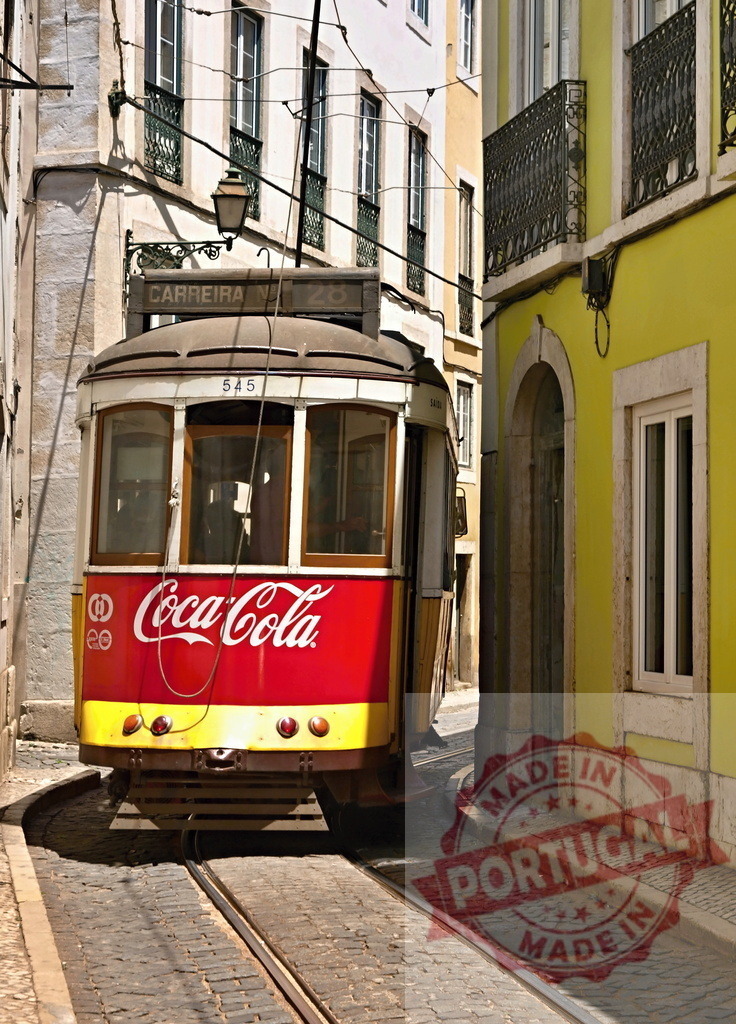 Vintage Lisbon tram passing through narrow street with Coca-Cola advertisement | Red and yellow vintage Lisbon tram passing through narrow street with Coca-Cola advertising - Realisiert mit Pictrs.com