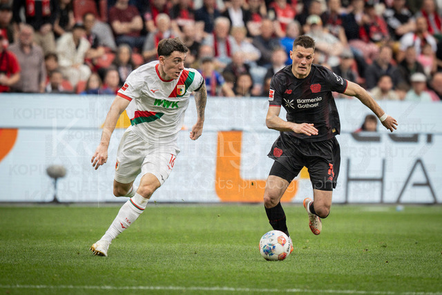 German Bundesliga, Bayer 04 Leverkusen vs. FC Augsburg, 18.04.2026 | LEVERKUSEN, GERMANY - APRIL 18, 2026 :  Cedric Zesiger (FC Augsburg, 16), Patrik Schick (Bayer 04 Leverkusen, 14) during the German Bundesliga match on gameday 30 between Bayer 04 Leverkusen vs. FC Augsburg at BayArena on April 18, 2026 in Leverkusen, Germany. DFL REGULATIONS PROHIBIT ANY USE OF PHOTOGRAPHS AS IMAGE SEQUENCES AND/OR QUASI-VIDEO.