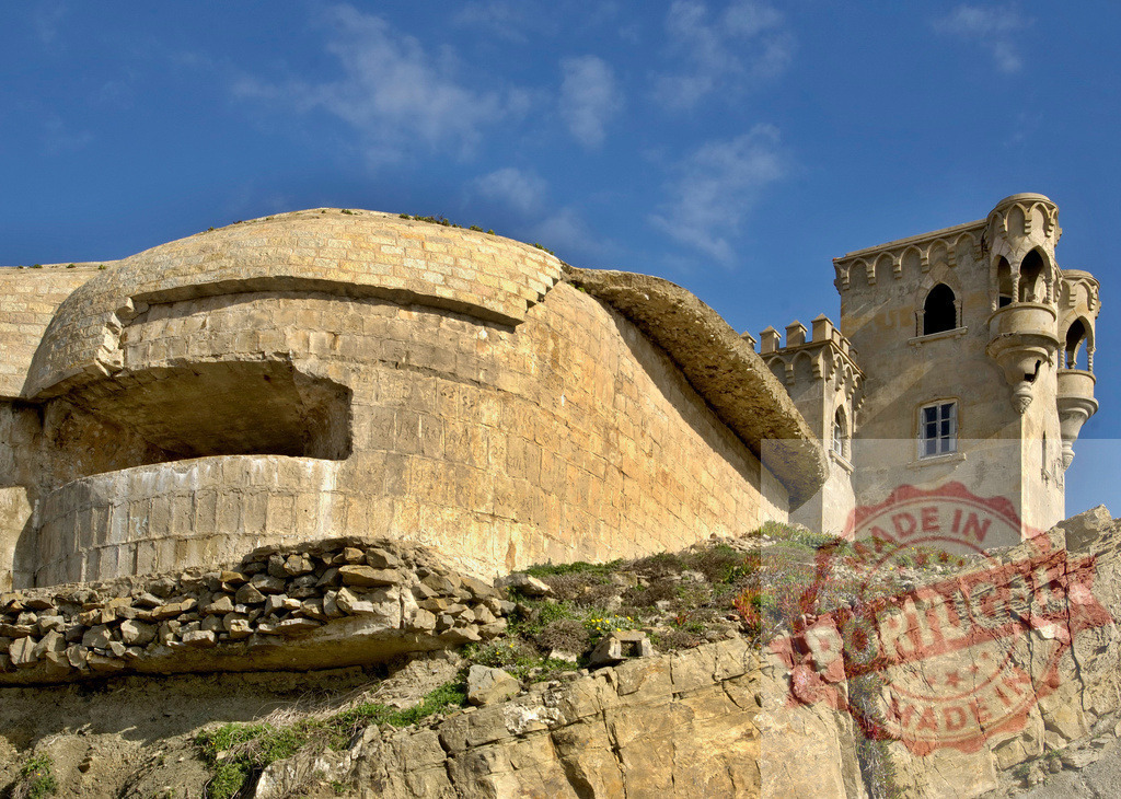 Castle Santa Catalina bunker and fairytale tower in Tarifa. Espana - Cadiz | Castle Santa Catalina fortress and a concrete bunker built on a rocky cliff under blue sky - Realized with Pictrs.com