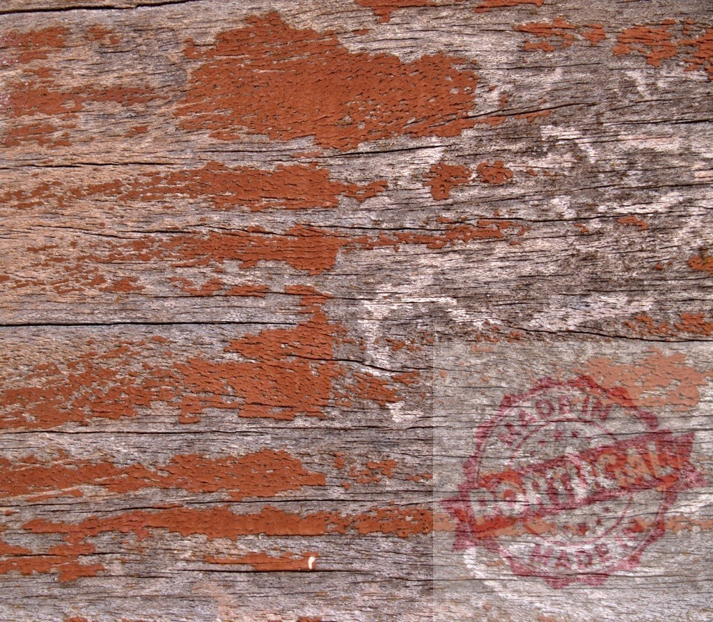 Old wooden plank with cracked orange paint showing wood grain | Close up of weathered wooden plank with cracked orange paint, highlighting wood grain and texture - Realized with Pictrs.com