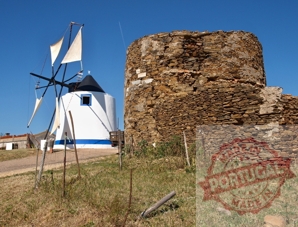 Alentejo rural landscape featuring traditional windmill and stone ruins | Restored traditional windmill standing next to historic stone ruins under a clear blue sky - Realized with Pictrs.com