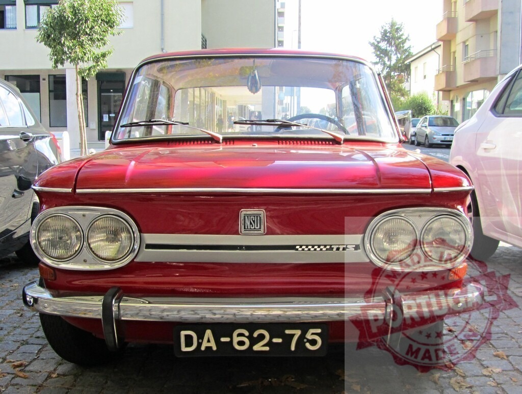 Red NSU Prinz TTS parked on a street | Classic red NSU Prinz TTS parked on a cobblestone street in an urban setting - Realized with Pictrs.com
