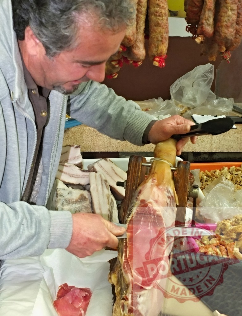 Butcher slicing cured ham on a stand in a market | Butcher preparing a traditional cured ham, slicing thin pieces for customers in a market - Realized with Pictrs.com