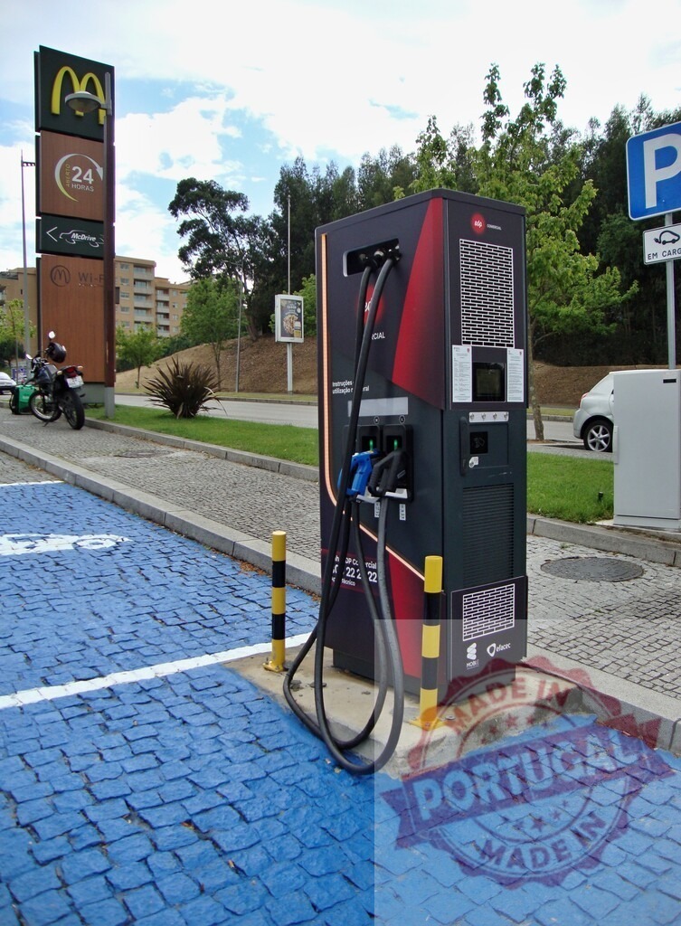 Electric vehicle charging station outside McDonalds restaurant | Modern EV charging station providing sustainable transportation options in urban environment - Realized with Pictrs.com