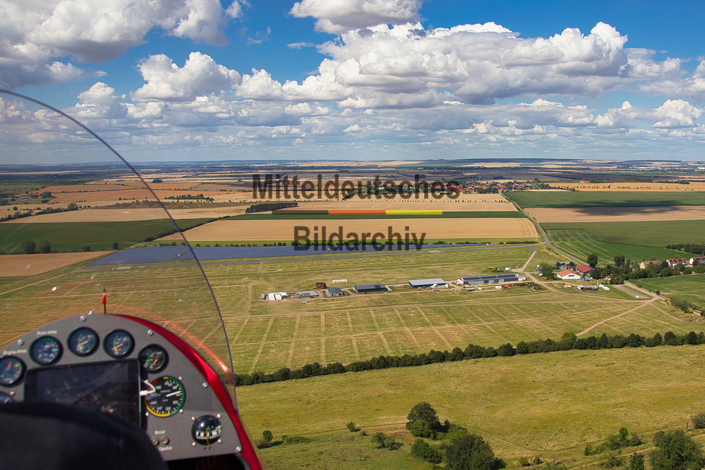 Pilot_4148 | Die Luftaufnahmen zeigen den Flugplatz Ballenstedt mit Start- und Landebahn, Hangars und dem umliegenden Harzvorland. Weitere Bilder entstanden direkt während des Fluges mit dem Tragschrauber. Mit dem Piloten im Vordergrund vermitteln sie einen authentischen Eindruck davon, aus welcher Perspektive meine Luftbilder entstehen und wie unmittelbar das Fotografieren aus dem offenen Tragschrauber ist.
 - Realisiert mit Pictrs.com