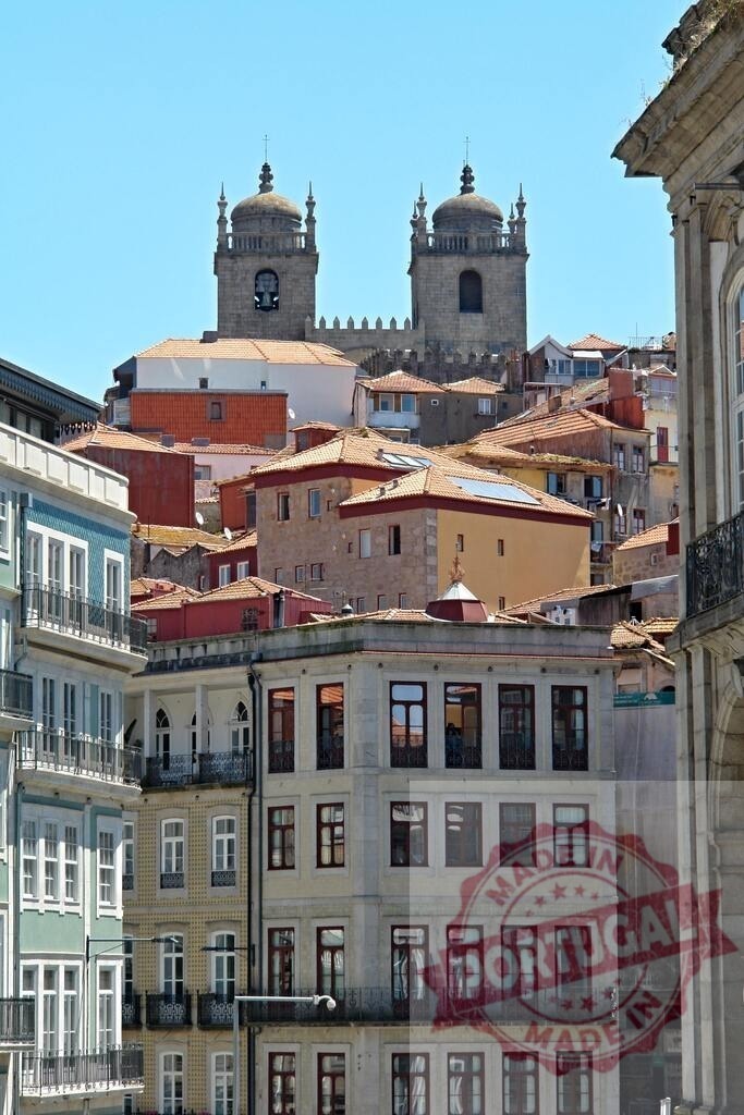 Porto Cathedral towers rising above old town homes | Historic Porto Cathedral dominating the city skyline with traditional colorful buildings - Realized with Pictrs.com