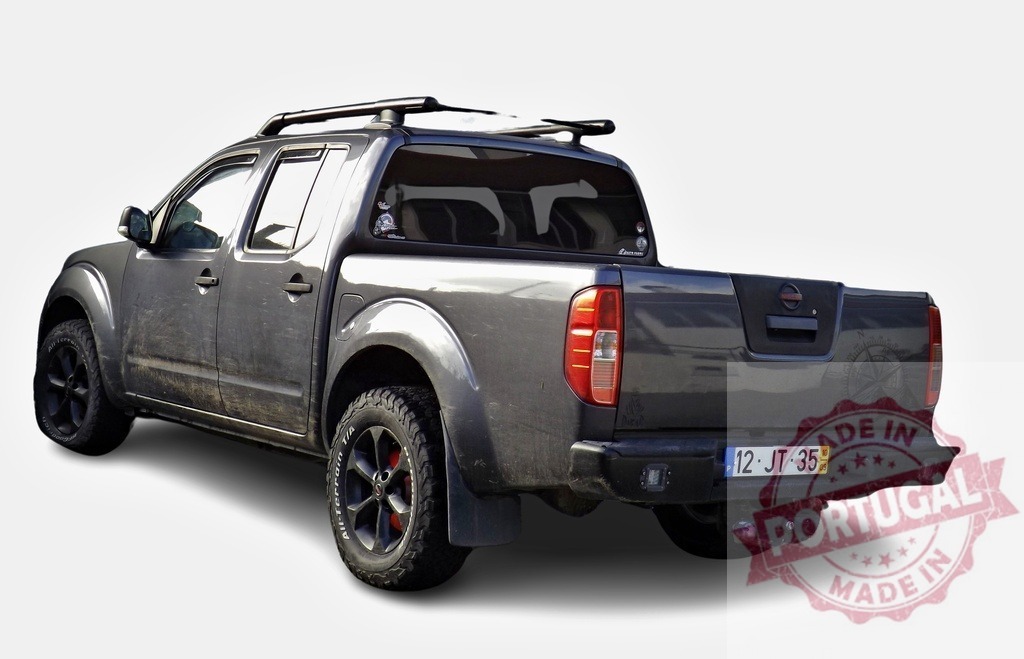 Nissan Navara pickup truck parking with roof rack and mudflaps | Gray Nissan Navara D40 pickup truck parking on white background, customized with roof rack, mudflaps and aftermarket black rims - Realisiert mit Pictrs.com