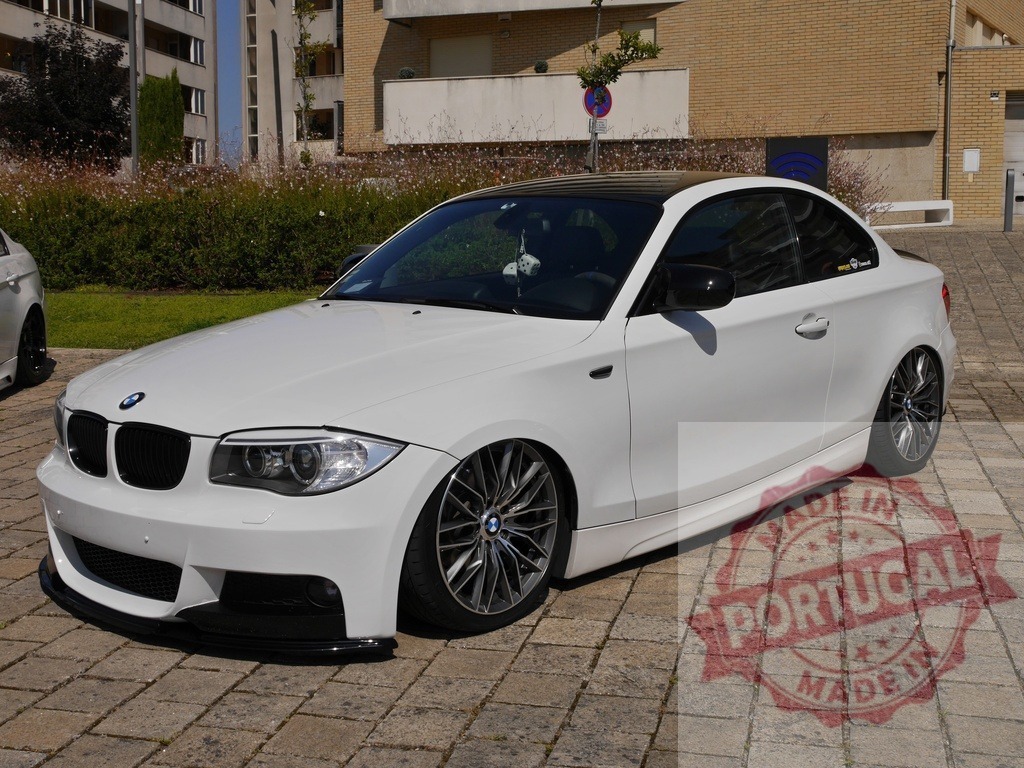 White BMW 1 Series coupe parked lowered on air suspension | Customized BMW 1 Series car showing tuning culture on display outdoors - Realized with Pictrs.com