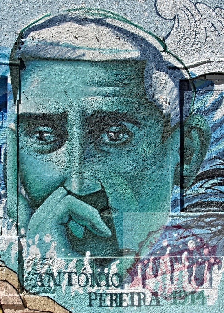 Thoughtful portrait of António Pereira depicted in a vibrant street art mural | Close-up of a captivating mural portraying António Pereira, his pensive expression captured in vibrant colors and artistic detail - Realisiert mit Pictrs.com