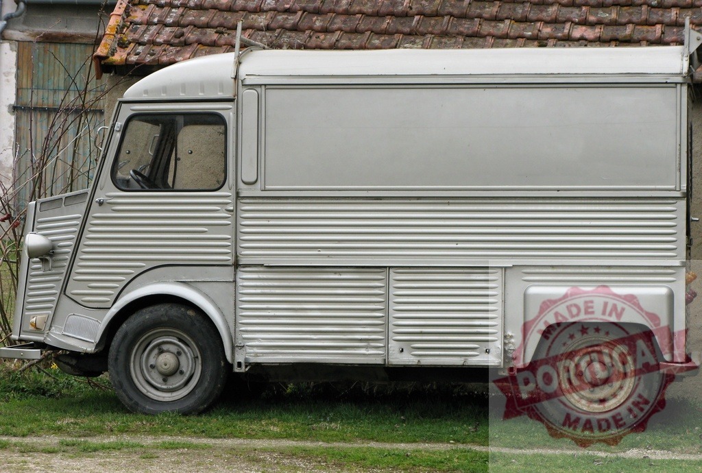 Citroën HY van parked near a rural house | Classic Citroën HY van parked on grass near a rural house with tiled roof, showing its iconic corrugated body - Realized with Pictrs.com