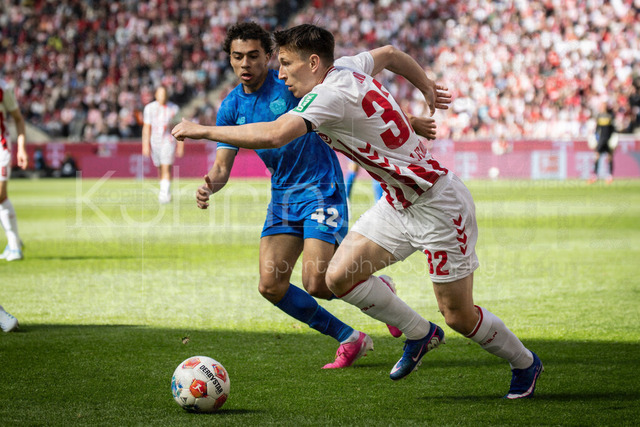 German Bundesliga,  1. FC Koeln - Bayer 04 Leverkusen, 25.04.2026 | KOELN, GERMANY - APRIL 25, 2026 :  Kristoffer Lund (1. FC Koeln, 32), Montrell Amare Culbreath  (Bayer 04 Leverkusen, 42) during the German Bundesliga match on gameday 31 between 1. FC Koeln - Bayer 04 Leverkusen at RheinEnergieSTADION on April 25, 2026 in Koeln, Germany. DFL REGULATIONS PROHIBIT ANY USE OF PHOTOGRAPHS AS IMAGE SEQUENCES AND/OR QUASI-VIDEO.