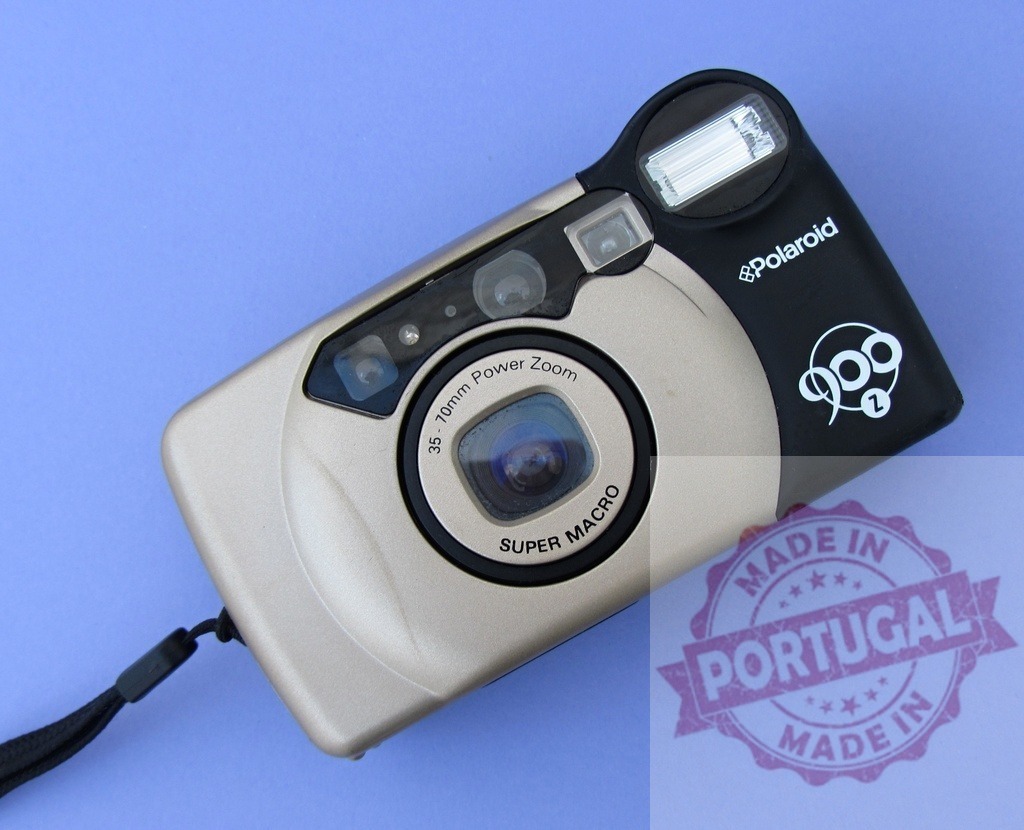 Polaroid 900Z compact film camera on purple background | Polaroid 900Z point and shoot camera, a retro vintage photography gadget - Realized with Pictrs.com