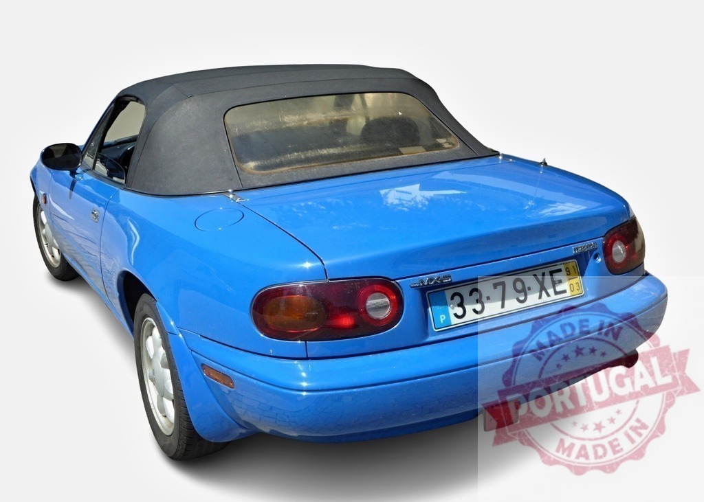 Blue Mazda MX-5 Miata showing its rear part with the roof closed | Rear view of a blue Mazda MX-5 with closed roof, parked and isolated on white - Realized with Pictrs.com