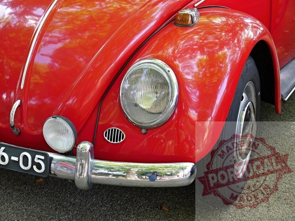 Red Volkswagen Beetle vintage car headlight | Red Volkswagen Beetle car's front fender with headlight, bumper, and tire parked on gravel - Realized with Pictrs.com